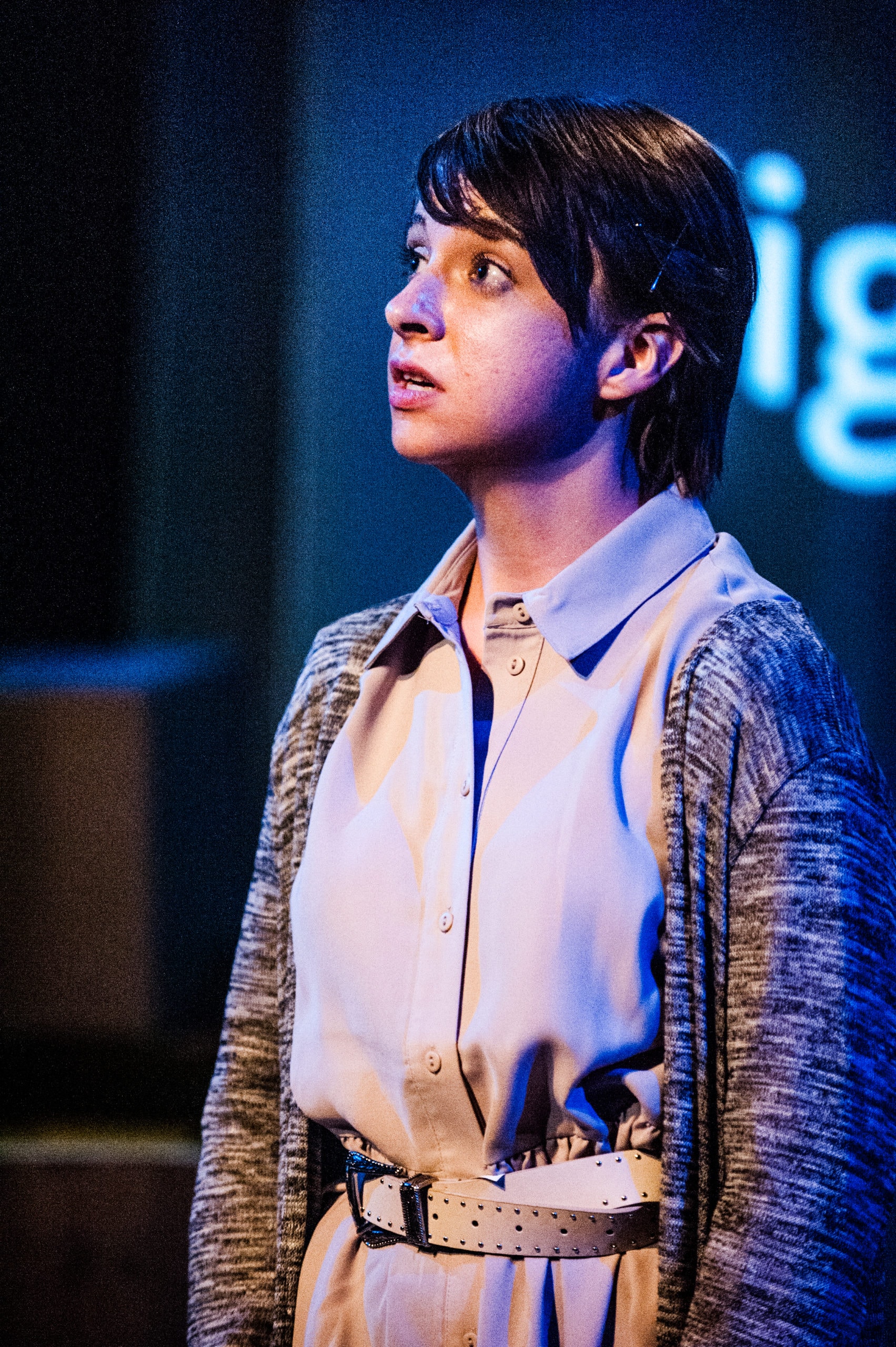 A young performer looks out towards the audience.