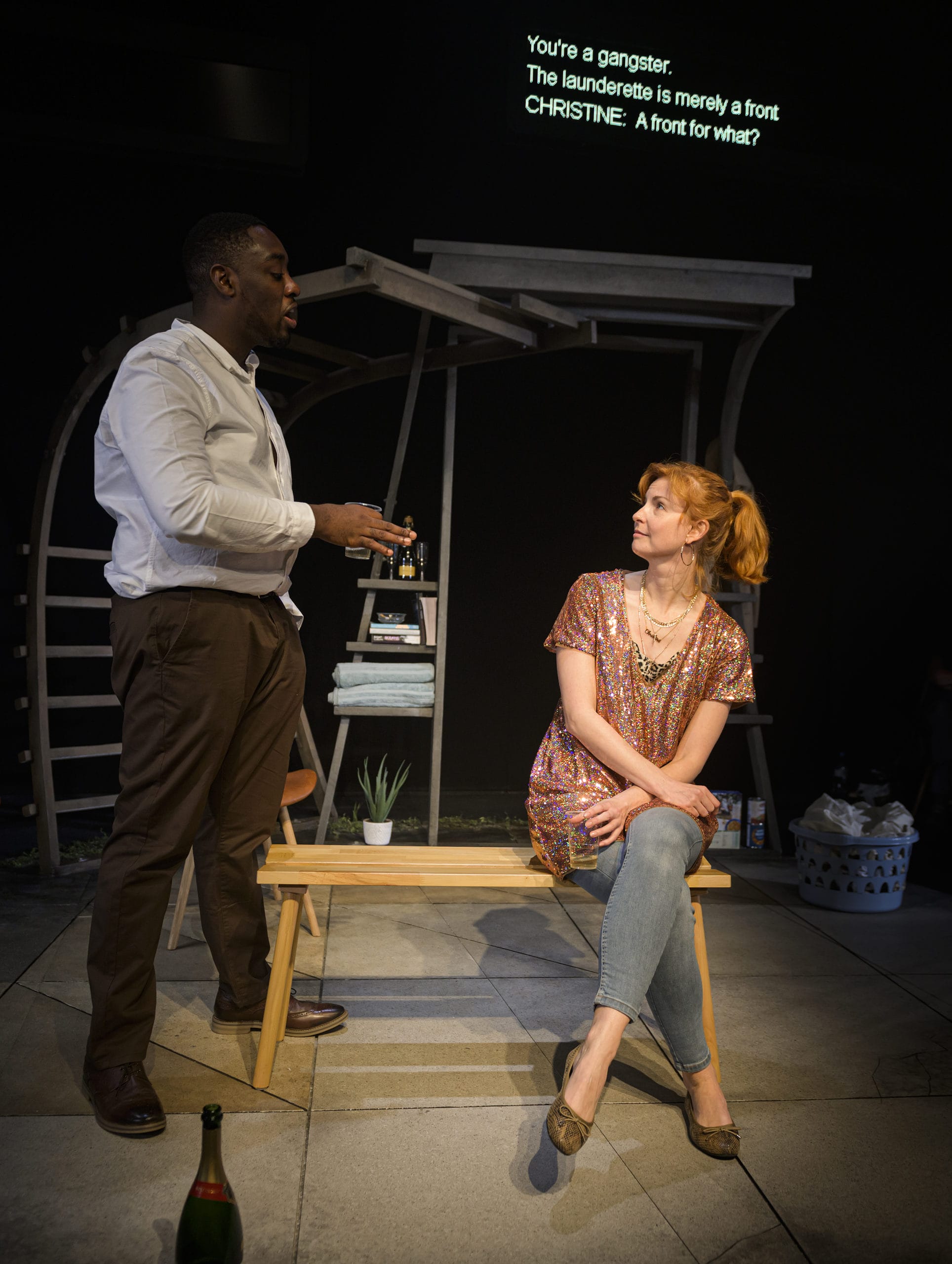 Stanley J Browne & Clare-Louise English on stage. Clare is seated and in conversation with the stood Stanley.