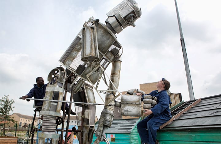 An image from the iron giant walk-about. A puppeteer operates the large iron giant puppet.