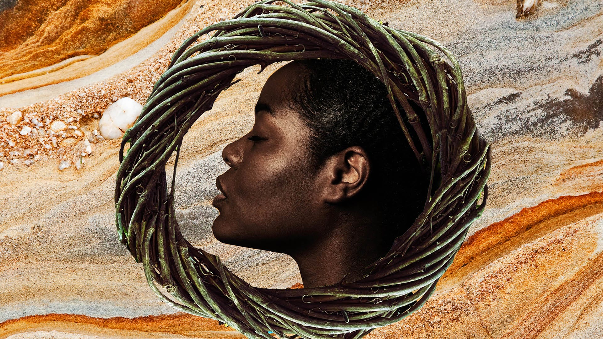The head of a black woman in a circle of woven sticks and reeds. She has her eyes closed and her mouth slightly open, she is looking directly to the right.