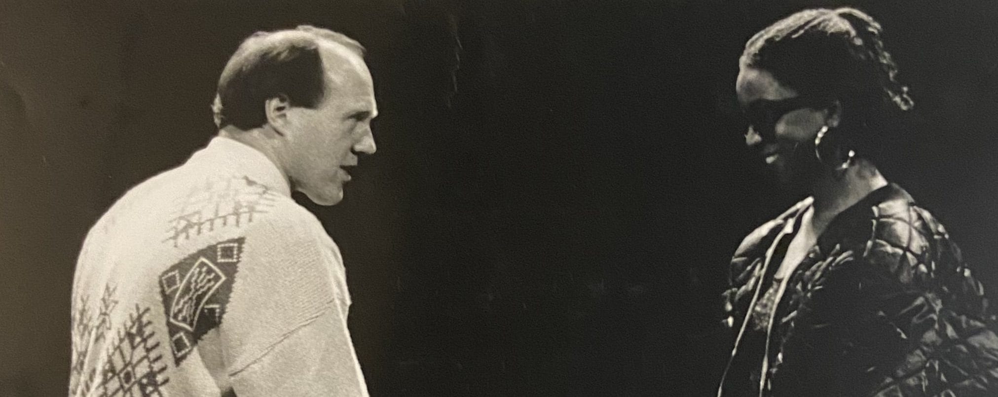 Two people stare each other down on stage.