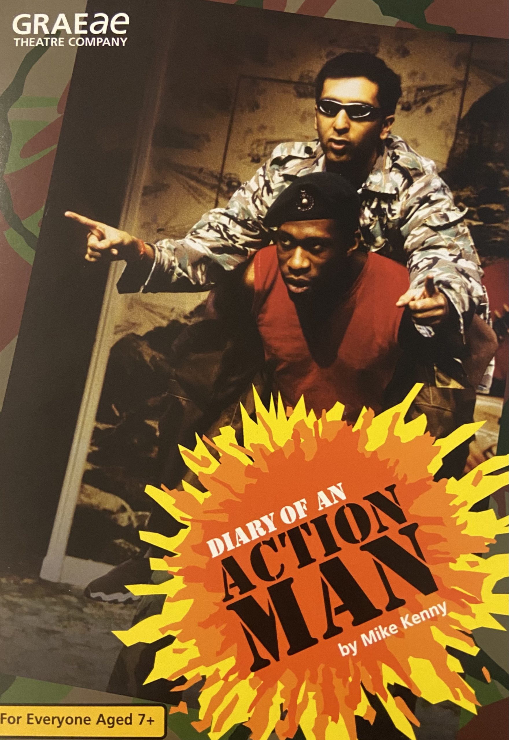 Poster for 'Diary of An Action Man'. It shows one man giving another man a piggy-back, the title of the show is written in a cartoon looking explosion.