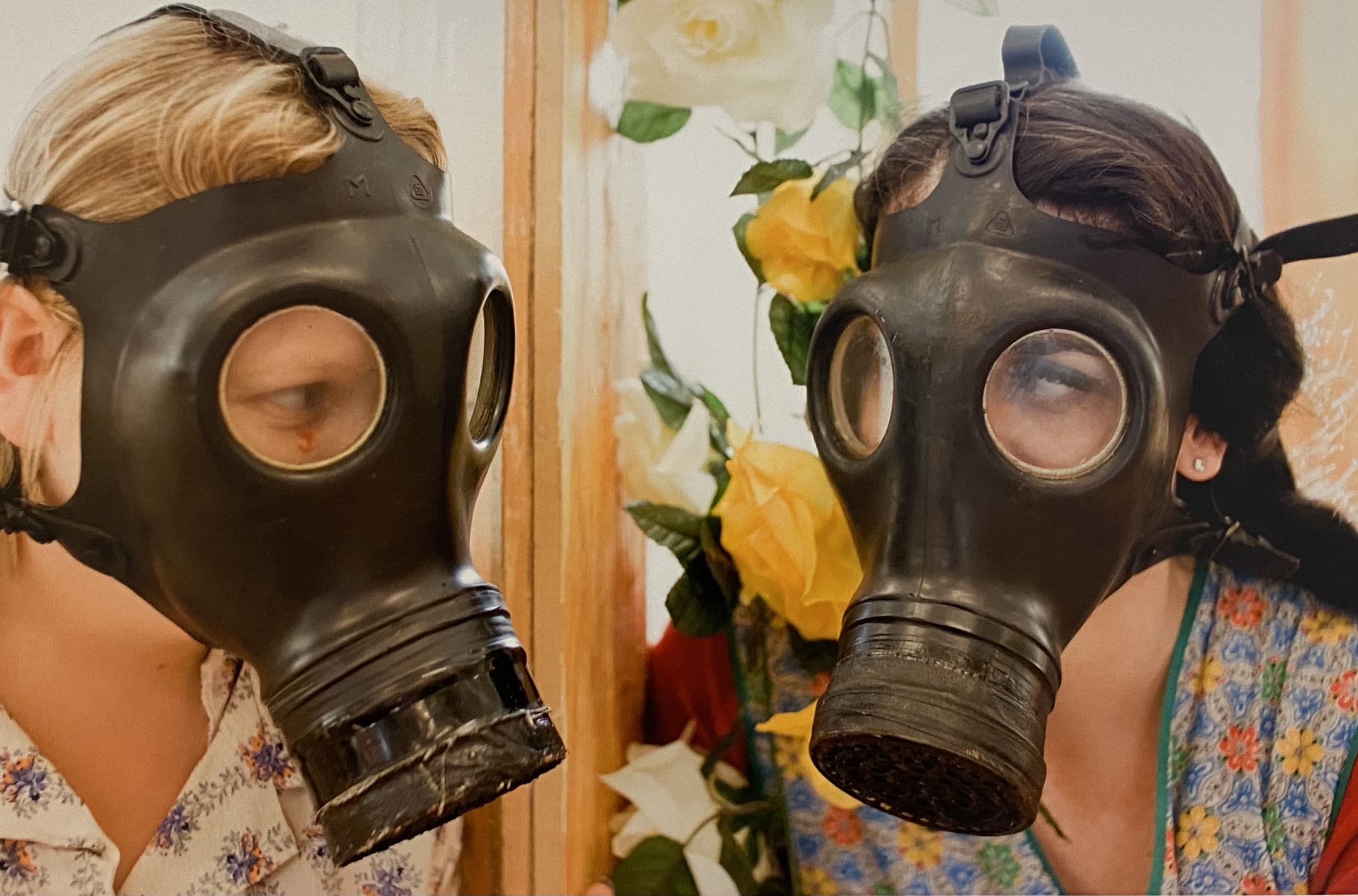 Two performers wearing gas masks.