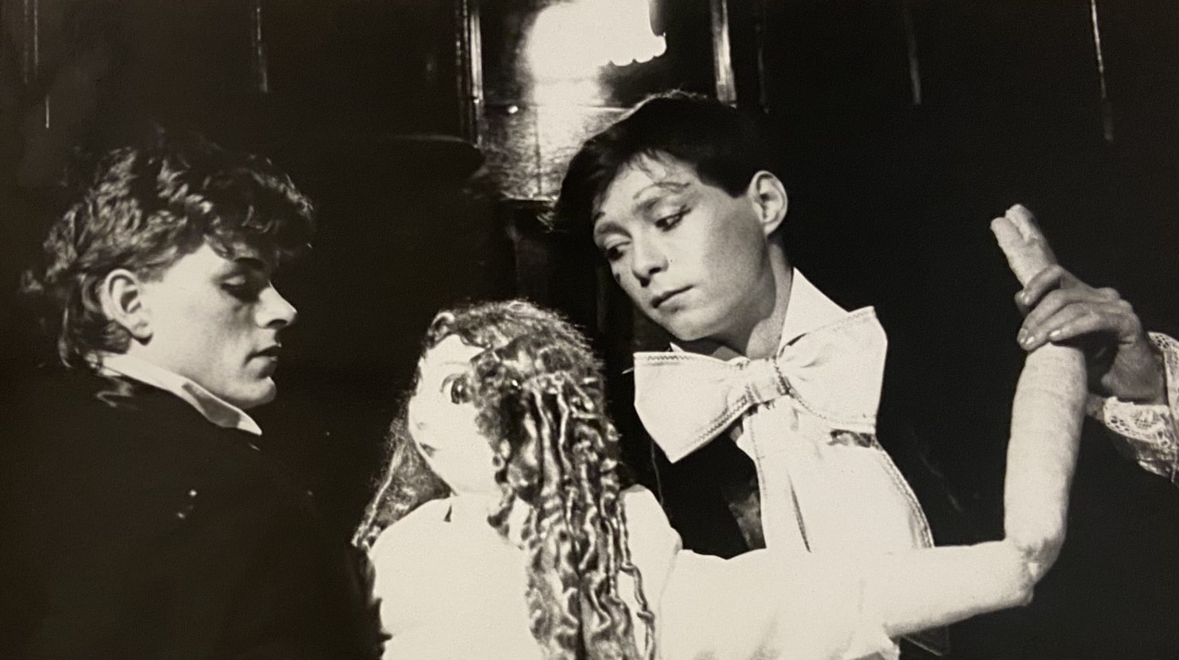 Two people puppeting a large puppet.