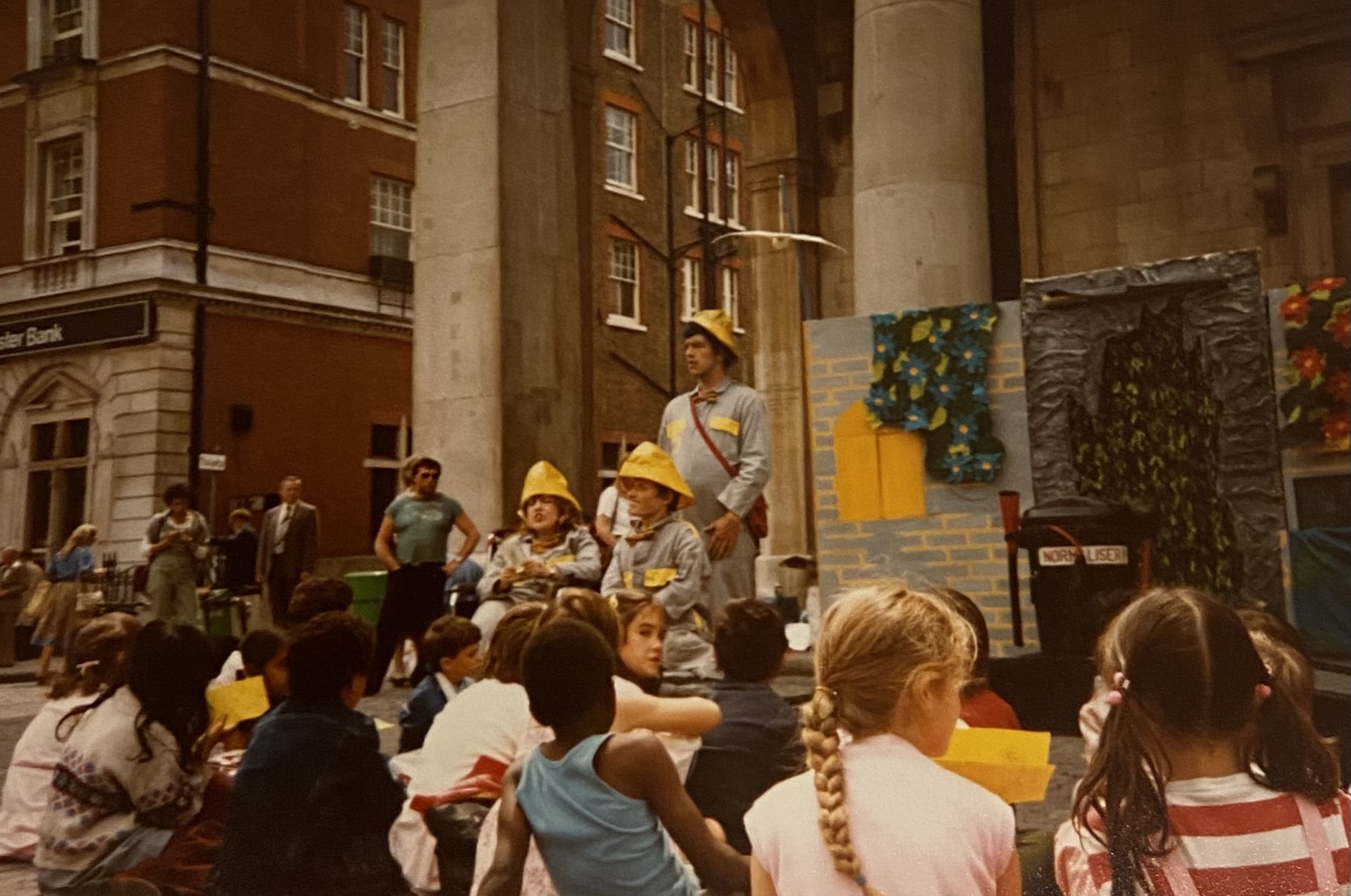 A gathering of people, some in yellow construction helmets.