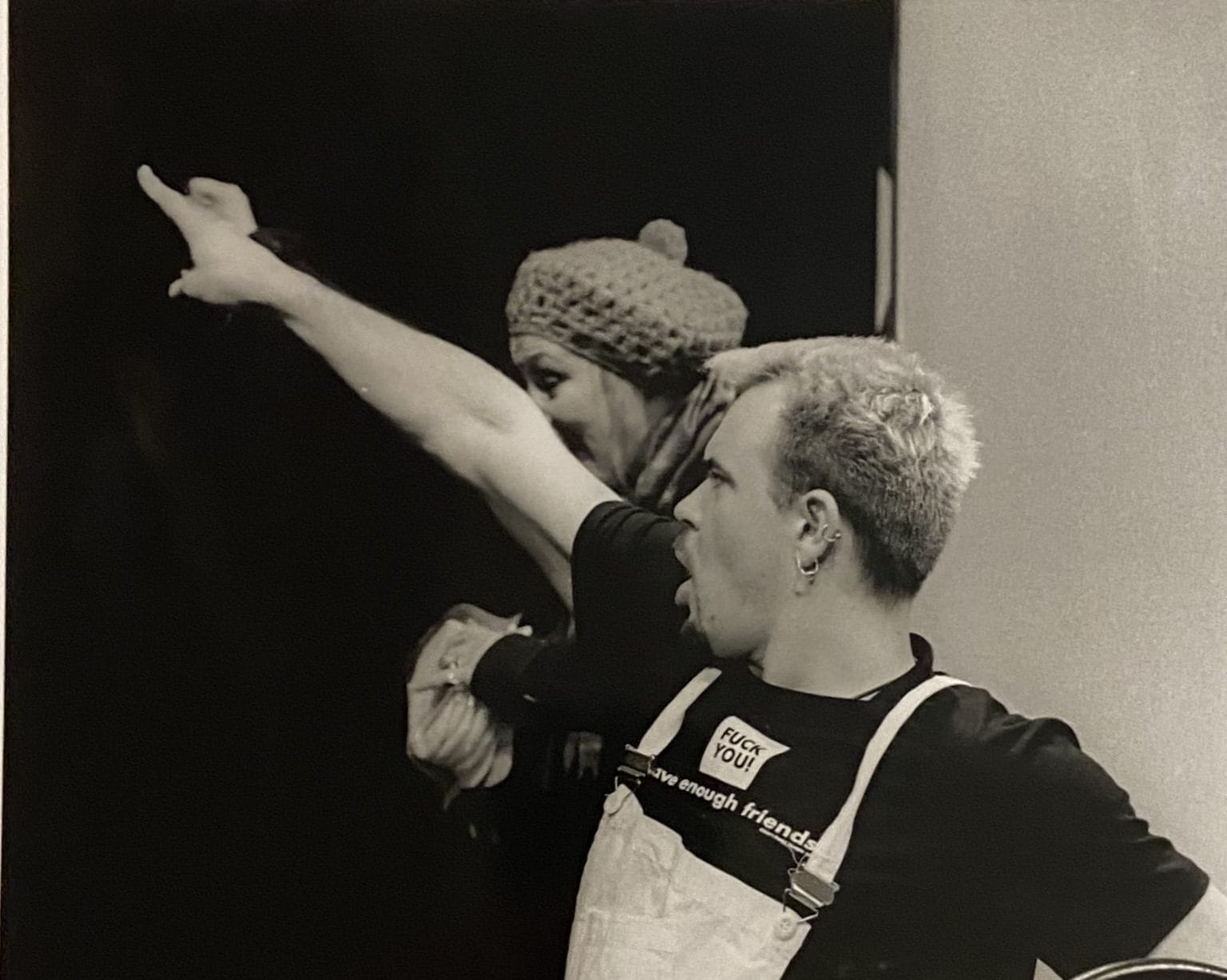 A male performer strikes a dramatic pose - pointing to something out of frame.