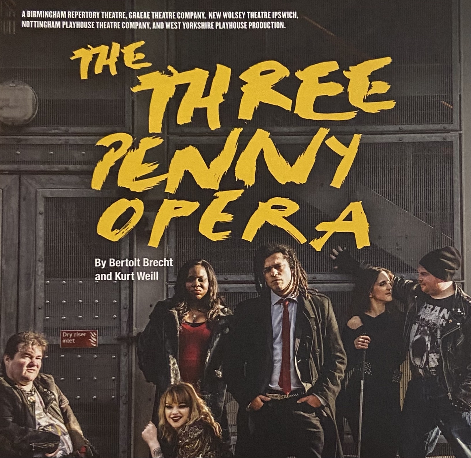 Poster for The Three Penny Opera, 6 performers pose looking menacingly at the camera