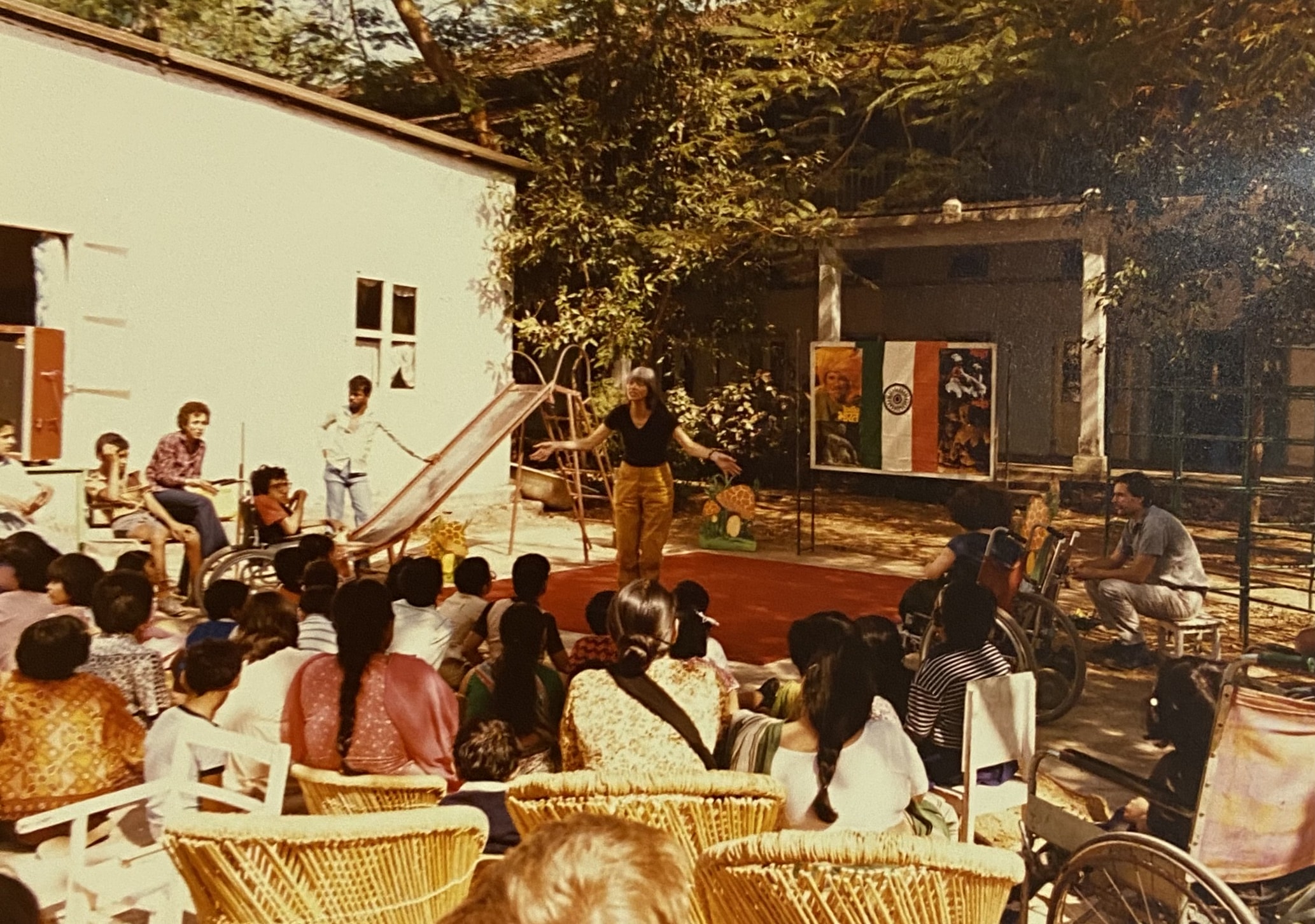 A gathering of people sat in a courtyard.