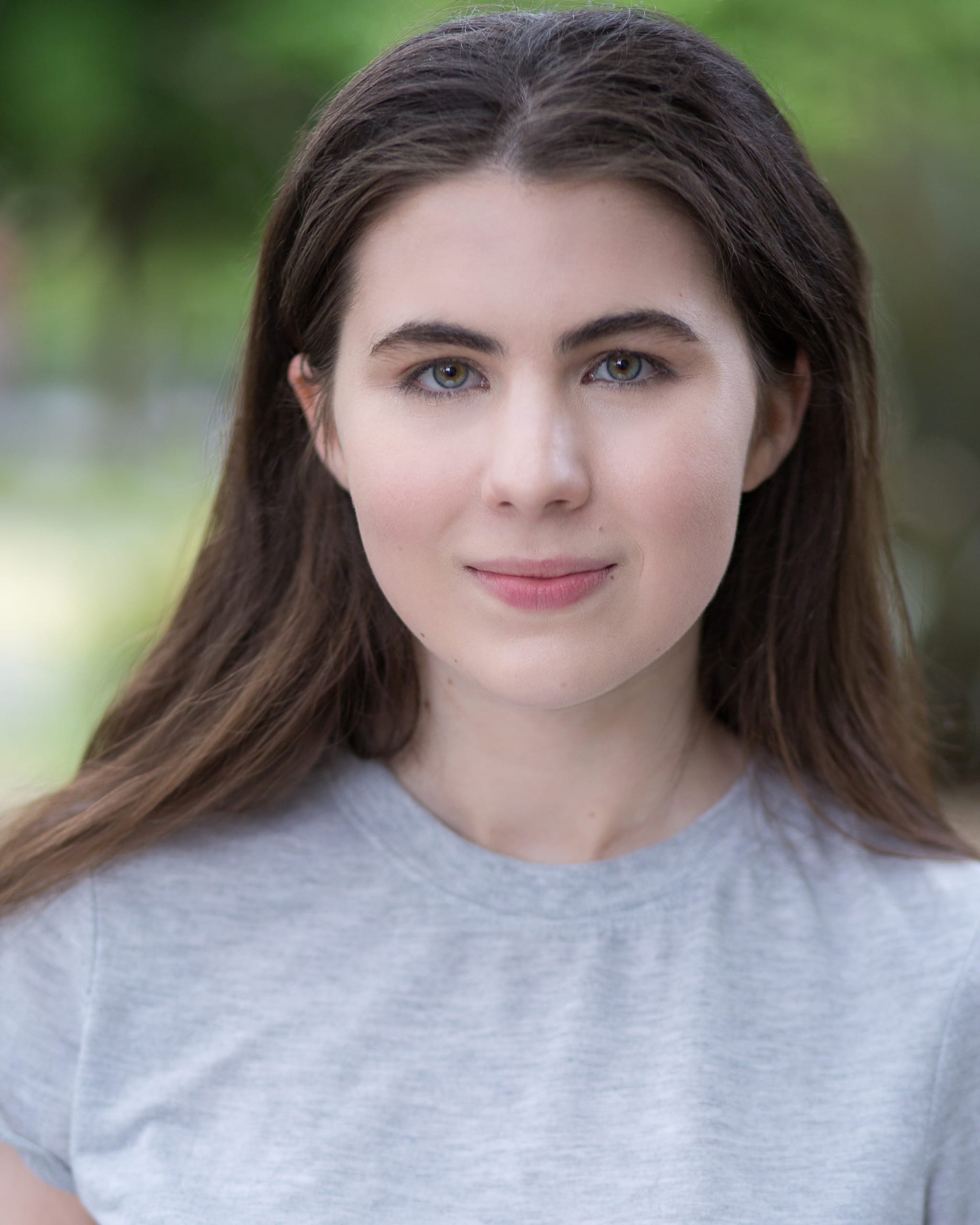 Image is a headshot of Beth, a white woman in her 20s with medium length dark brown hair.