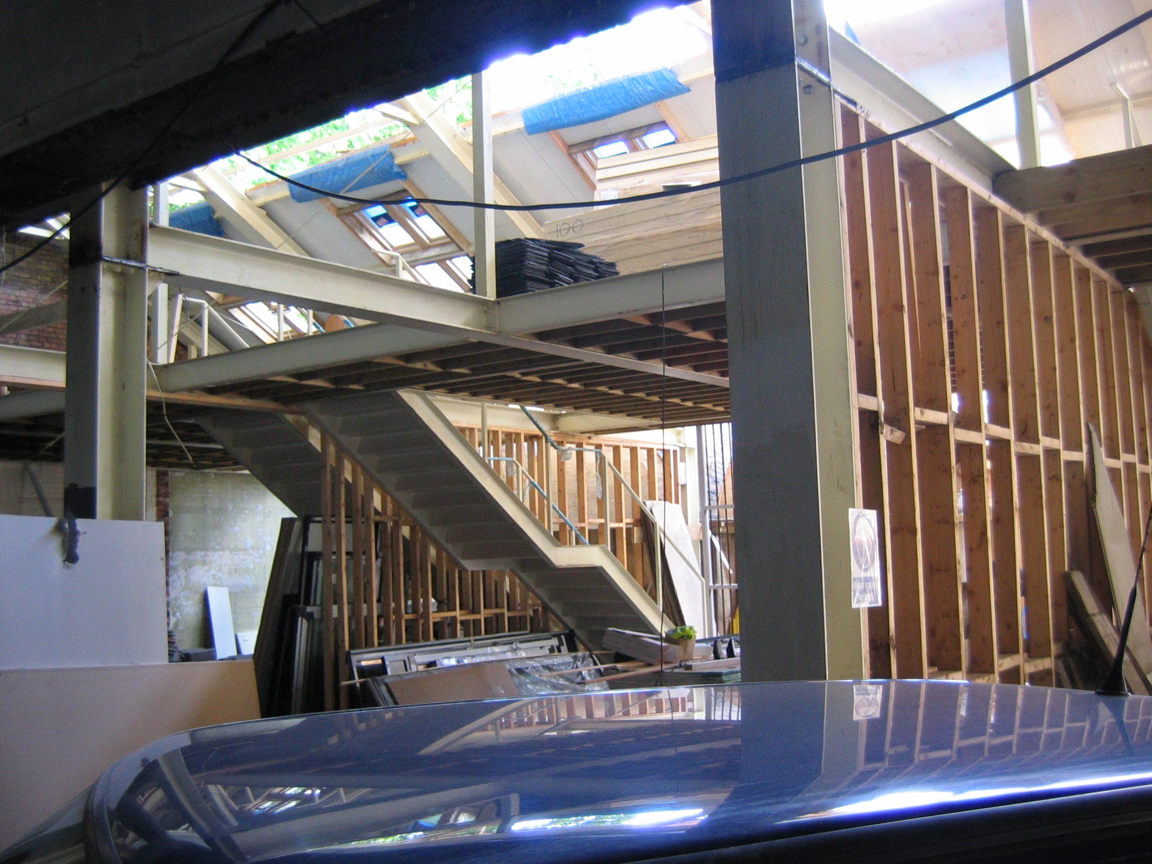Colour photo of the inside of Bradbury Studios. This is during the construction phase of the Capital project in 2008. There are large wooden structures that will eventually become walls and stairs. The roof of a blue car can also be seen on the edge of the image.
