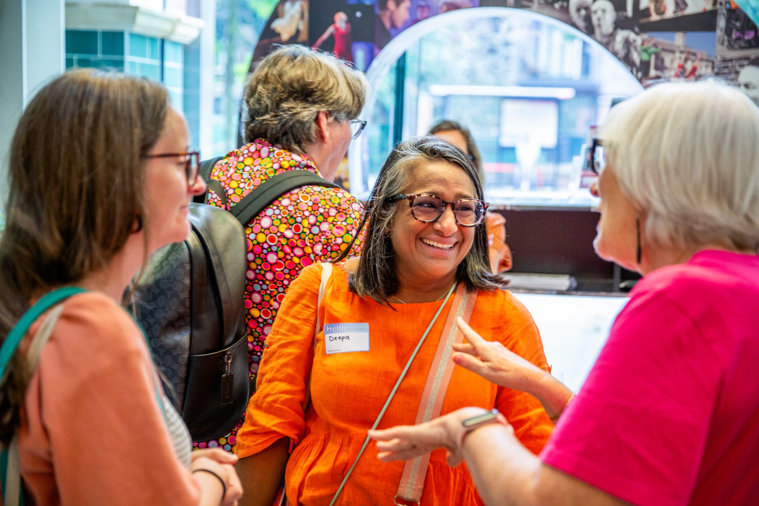 Three women speaking in Graeae's building