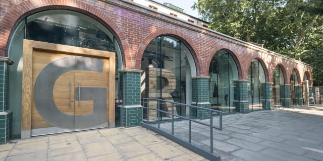 Outside of grey eye's offices. There are arched windows with letters spelling out grey eye in them.