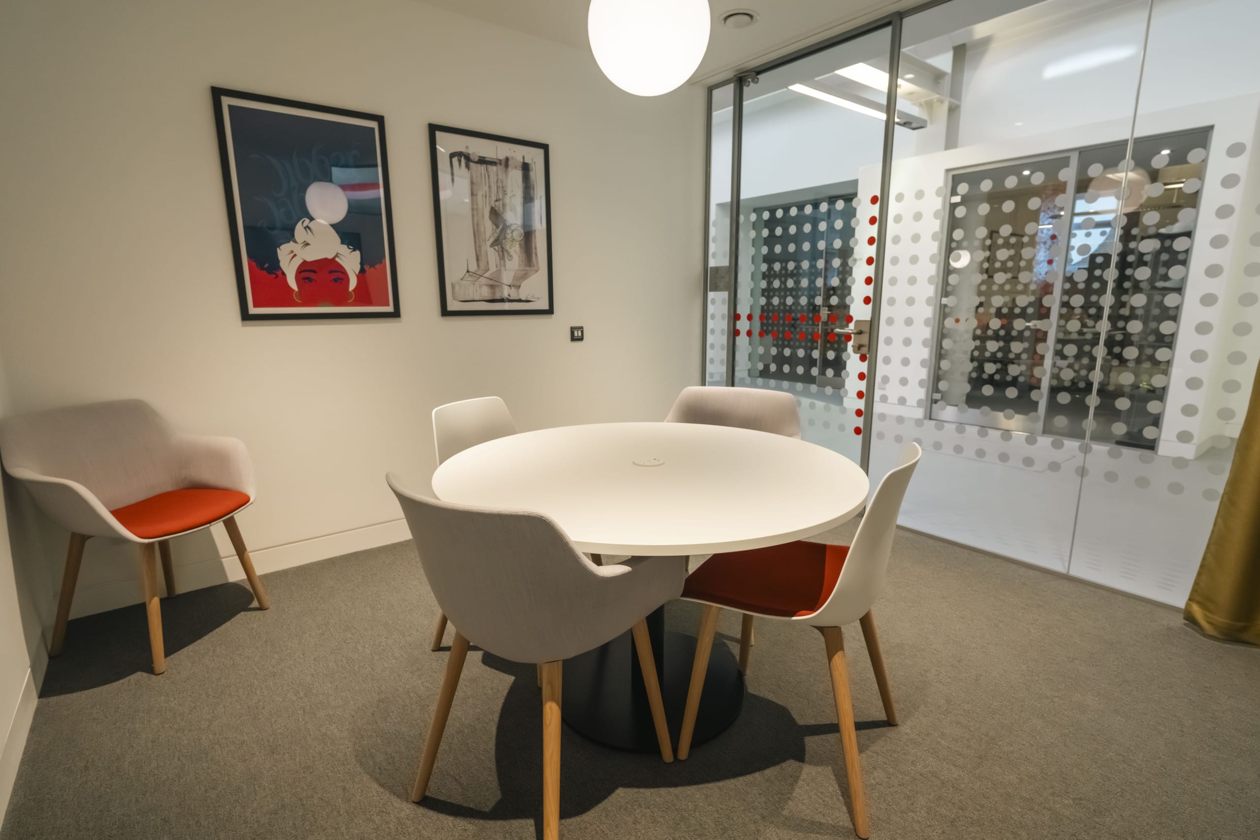 Meeting room with a small circle table with a glass wall in the background