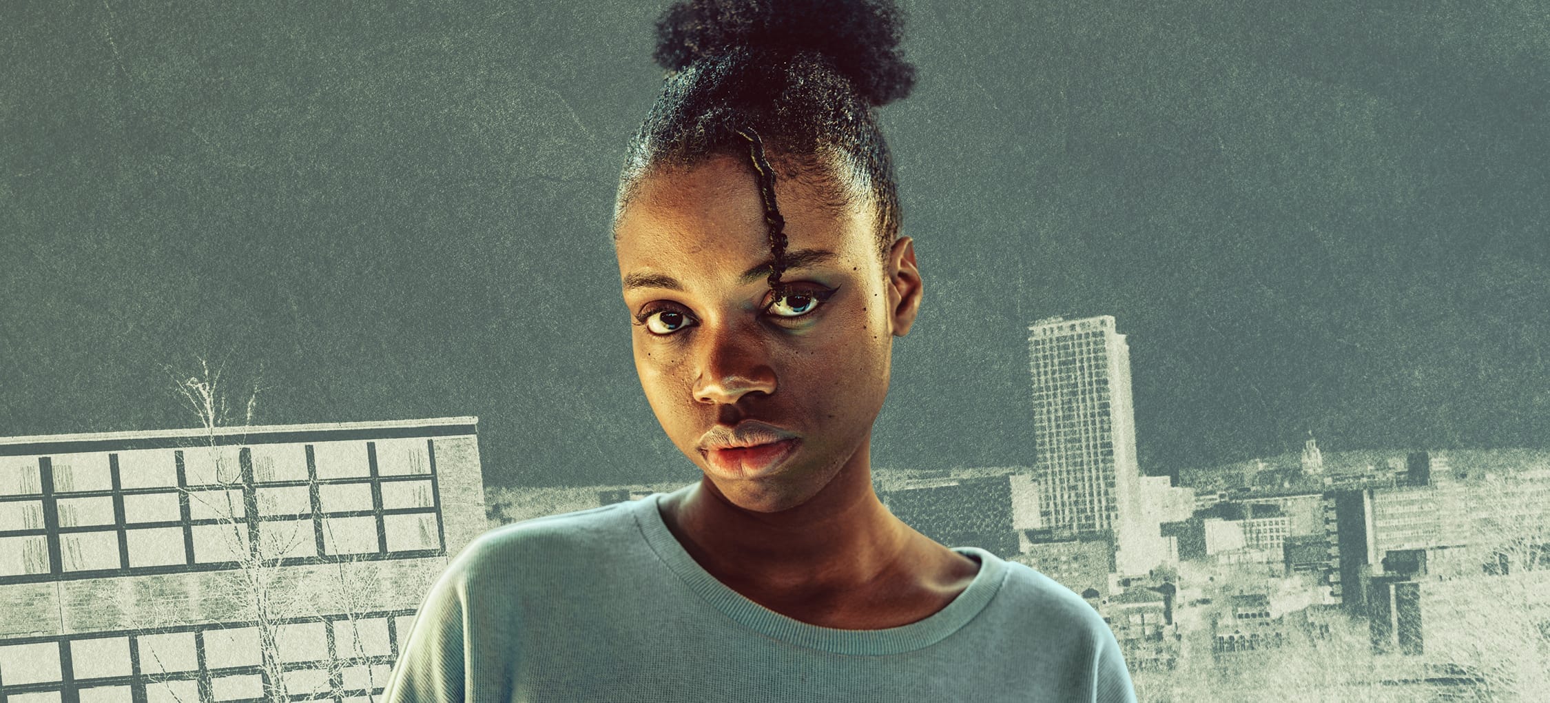 A young black woman witt braids tied up wearing a grey tshirt with a city landscape in the background. Text reads 12 letters to my name